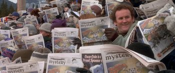 Movie still from “Mystery, Alaska” (1999), directed by Jay Roach – A group of people holding up newspapers in front of their faces; Close Up shot, High angle