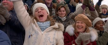 Movie still from “Mystery, Alaska” (1999), directed by Jay Roach – A group of people sitting and standing in a crowd; Medium shot, High angle