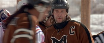 Movie still from “Mystery, Alaska” (1999), directed by Jay Roach – A man in a hockey uniform with a helmet on; Close Up shot, Low angle