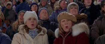 Movie still from “Mystery, Alaska” (1999), directed by Jay Roach – A group of people sitting in a stadium watching a game; Close Up shot, High angle