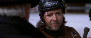 Movie still from “Mystery, Alaska” (1999), directed by Jay Roach – A person wearing a hockey helmet; Close Up shot, Over the shoulder angle