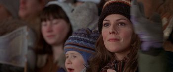 Movie still from “Mystery, Alaska” (1999), directed by Jay Roach – A person wearing a hat and a scarf; Close Up shot, Over the shoulder angle