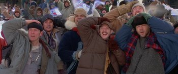 Movie still from “Mystery, Alaska” (1999), directed by Jay Roach – A group of people standing in a crowd; Medium shot, High angle