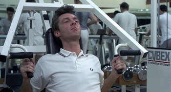 Movie still from “Naked” (1993), directed by Mike Leigh – A man is working out in a gym; Close Up shot, Low angle