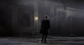 Movie still from “Naked” (1993), directed by Mike Leigh – A man standing in the middle of an empty street; Wide shot, Low angle