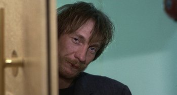 Movie still from “Naked” (1993), directed by Mike Leigh – A person with long hair; Close Up shot, Over the shoulder angle