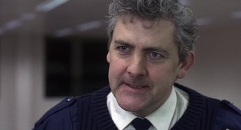 Movie still from “Naked” (1993), directed by Mike Leigh – A person wearing a tie; Close Up shot, Low angle