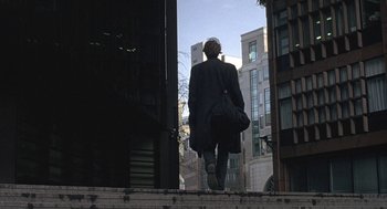 Movie still from “Naked” (1993), directed by Mike Leigh – A man walking down the steps of a building; Wide shot, Low angle