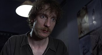 Movie still from “Naked” (1993), directed by Mike Leigh – A person with a beard; Close Up shot, Low angle