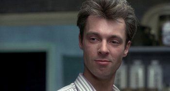 Movie still from “Naked” (1993), directed by Mike Leigh – A person wearing a striped shirt; Close Up shot, Low angle