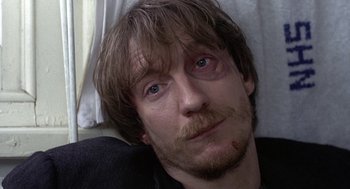 Movie still from “Naked” (1993), directed by Mike Leigh – A person laying on a bed; Close Up shot, High angle