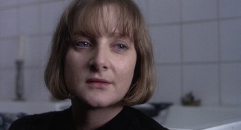 Movie still from “Naked” (1993), directed by Mike Leigh – A person with short hair; Close Up shot, Over the shoulder angle