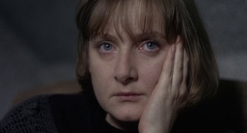 Movie still from “Naked” (1993), directed by Mike Leigh – A person holding her head with her hand; Close Up shot, Over the shoulder angle