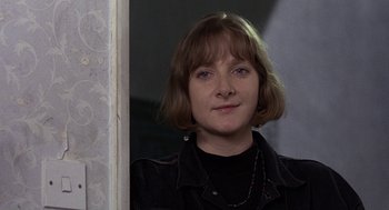 Movie still from “Naked” (1993), directed by Mike Leigh – A person with short hair; Close Up shot, Low angle