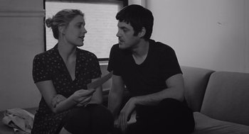 Movie still from “Frances Ha” (2012), directed by Noah Baumbach – A man and a woman sitting on a couch talking to each other; Medium shot, Over the shoulder angle