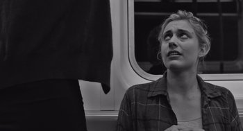 Movie still from “Frances Ha” (2012), directed by Noah Baumbach – A woman sitting on a train looking up at the window; Close Up shot, Over the shoulder angle