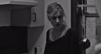 Movie still from “Frances Ha” (2012), directed by Noah Baumbach – A woman standing in a kitchen looking down at the floor; Close Up shot, Over the shoulder angle