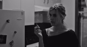 Movie still from “Frances Ha” (2012), directed by Noah Baumbach – A woman smoking a cigarette in a kitchen; Close Up shot, Low angle