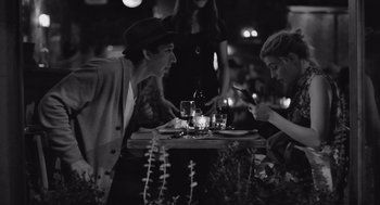 Movie still from “Frances Ha” (2012), directed by Noah Baumbach – A man and a woman sitting at a dinner table; Medium shot, Over the shoulder angle