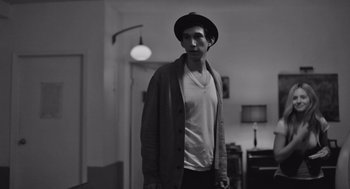 Movie still from “Frances Ha” (2012), directed by Noah Baumbach – A young man wearing a hat and a sweater; Medium shot, Over the shoulder angle