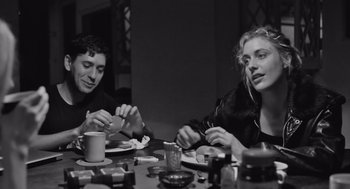 Movie still from “Frances Ha” (2012), directed by Noah Baumbach – A man and a woman sitting at a dinner table; Medium shot, Over the shoulder angle