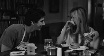 Movie still from “Frances Ha” (2012), directed by Noah Baumbach – A man and a woman sitting at a dinner table; Medium shot, Over the shoulder angle