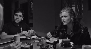 Movie still from “Frances Ha” (2012), directed by Noah Baumbach – Two people sitting at a dinner table eating; Medium shot, Over the shoulder angle