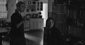 Movie still from “Frances Ha” (2012), directed by Noah Baumbach – Two women are standing in a living room; Medium shot, Over the shoulder angle