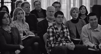 Movie still from “Frances Ha” (2012), directed by Noah Baumbach – A group of people are sitting in a room together; Medium shot, Over the shoulder angle