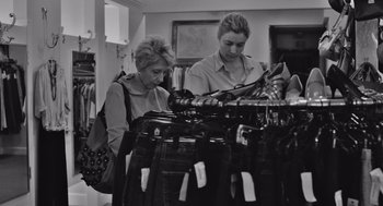 Movie still from “Frances Ha” (2012), directed by Noah Baumbach – Two women looking at bags in a clothing store; Medium shot, Over the shoulder angle