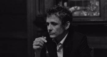 Movie still from “Frances Ha” (2012), directed by Noah Baumbach – Black and white photograph of a man in a suit; Close Up shot, Over the shoulder angle