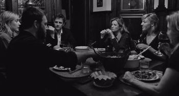 Movie still from “Frances Ha” (2012), directed by Noah Baumbach – A group of people sitting around a table eating; Medium shot, Over the shoulder angle