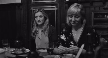 Movie still from “Frances Ha” (2012), directed by Noah Baumbach – Two women sitting at a dinner table with wine glasses; Close Up shot, Over the shoulder angle