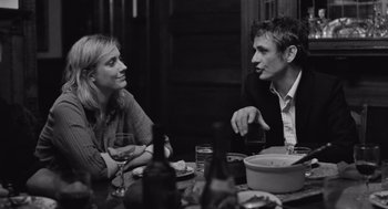 Movie still from “Frances Ha” (2012), directed by Noah Baumbach – A man and a woman sitting at a dinner table; Medium shot, Over the shoulder angle