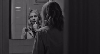 Movie still from “Frances Ha” (2012), directed by Noah Baumbach – A woman brushing her teeth in front of a mirror; Close Up shot, Over the shoulder angle