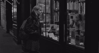 Movie still from “Frances Ha” (2012), directed by Noah Baumbach – A woman standing in front of a store window; Medium shot, Over the shoulder angle