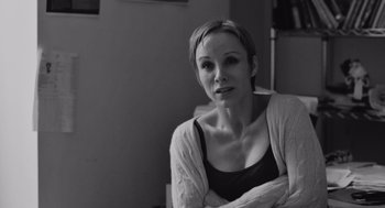 Movie still from “Frances Ha” (2012), directed by Noah Baumbach – Black and white photograph of a woman with her arms crossed; Close Up shot, Over the shoulder angle