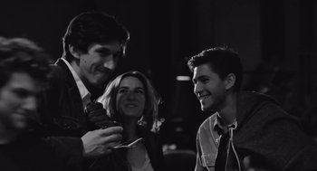 Movie still from “Frances Ha” (2012), directed by Noah Baumbach – A man and a woman and a young man are smiling; Close Up shot, Over the shoulder angle