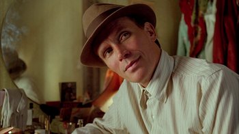 Movie still from “Naked Lunch” (1991), directed by David Cronenberg – A person wearing a hat; Close Up shot, Low angle