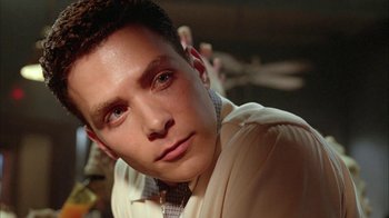 Movie still from “Naked Lunch” (1991), directed by David Cronenberg – A person wearing a shirt and tie; Close Up shot, Low angle