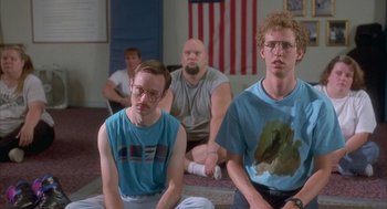 Movie still from “Napoleon Dynamite” (2004), directed by Jared Hess – A group of people sitting in a room; Medium shot, Low angle