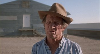 Movie still from “Napoleon Dynamite” (2004), directed by Jared Hess – An older man wearing a brown hat and a blue shirt; Close Up shot, Low angle