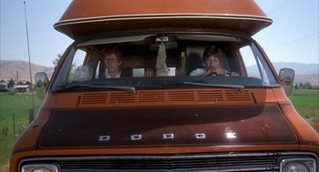 Movie still from “Napoleon Dynamite” (2004), directed by Jared Hess – Two men sitting in the drivers seat of an old bus; Medium shot, Low angle