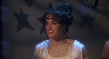 Movie still from “Napoleon Dynamite” (2004), directed by Jared Hess – A young woman with long black hair wearing a white dress; Close Up shot, Over the shoulder angle