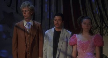 Movie still from “Napoleon Dynamite” (2004), directed by Jared Hess – A group of people standing next to each other on a stage; Medium shot, Low angle