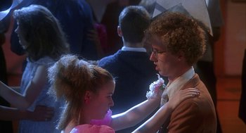 Movie still from “Napoleon Dynamite” (2004), directed by Jared Hess – A man and a woman are dressed up for a dance; Medium shot, Overhead angle