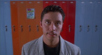 Movie still from “Napoleon Dynamite” (2004), directed by Jared Hess – A man with a mustache in front of two lockers in a room; Close Up shot, Low angle