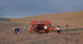 Movie still from “Napoleon Dynamite” (2004), directed by Jared Hess – A group of people standing in a field with a van; Extreme Wide shot, Low angle