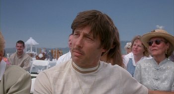 Movie still from “Napoleon Dynamite” (2004), directed by Jared Hess – A man with a beard and mustache wearing a white shirt; Close Up shot, Low angle