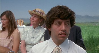 Movie still from “Napoleon Dynamite” (2004), directed by Jared Hess – A man and a woman wearing hats and a tie; Close Up shot, Low angle